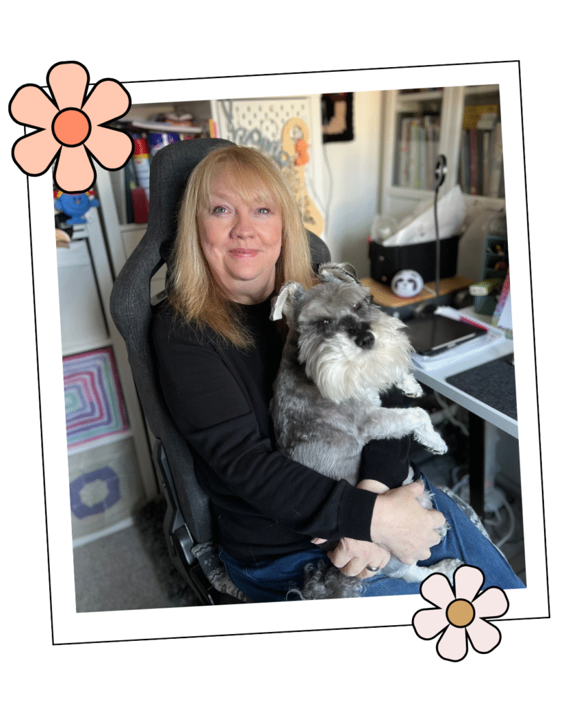 jane burns knitting and crochet designer at her desk wither her dog bertie